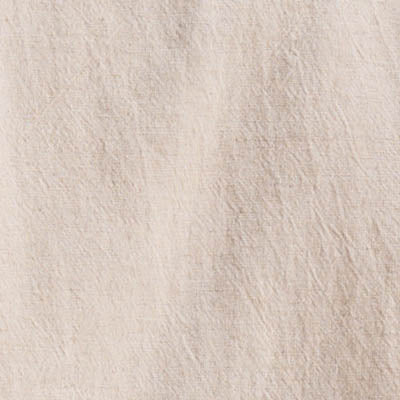 Close-up of a beige, textured NZ fabric with visible creases and fibers.